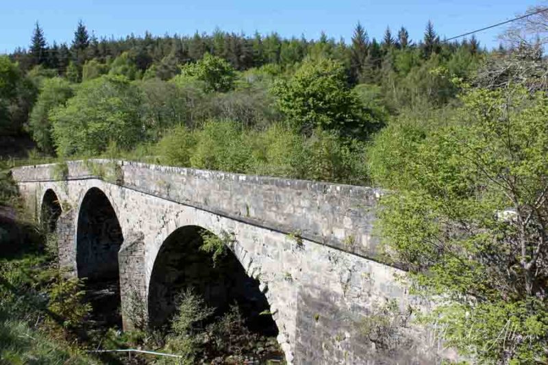 Archways under a bridge made of stone in the Scottish Highlands