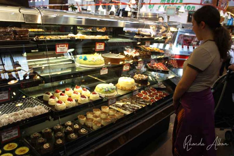 Vancouver Itinerary: Enjoying an Exquisite Canadian City 19 Girl looking at sweets at a booth in the Public Market on Granville Island