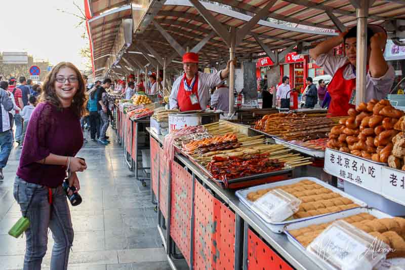 Beijing Street Food from Spiders to Snakes on Wangfujing Snack Street 3 Girl shopping at a Beijing street food market