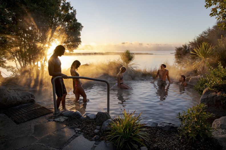 14 Best New Zealand Hot Springs - Relax, Soak, Unwind 3 woman relaxing in a hot pool at Polynesian Spa, one of the award winning New Zealand hot springs