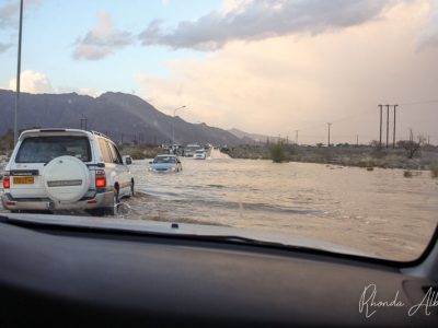 Desert flood water with cars stuck in the flood