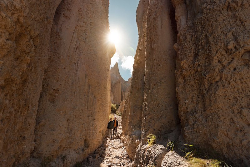 Christchurch to Queenstown Road Trip: Our Favourite Stops 14 Two people walking in a narrow passage way at the Omarama Clay Cliffs