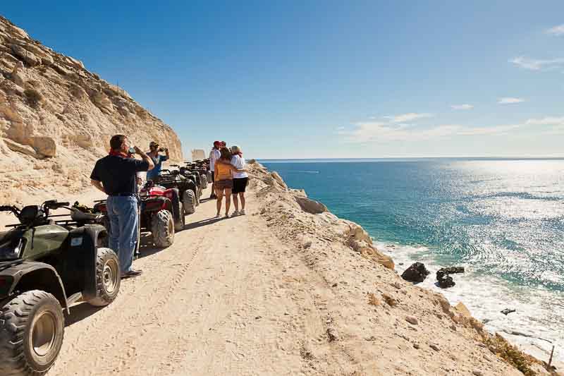 Unique Things to Do in Cabo San Lucas Mexico - Cruise Port Ideas 14 Guests of an ATV tour enjoy a rest and the coastline of the Sea of Cortez. These ATV tours take riders from the desert terrain to the sea.