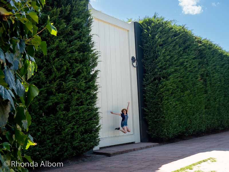 Hamilton Gardens - 18 Incredible Themed Gardens in Waikato NZ 13 Sarah Albom jumping in front of the giant door in the Surreal Garden, Hamilton Gardens