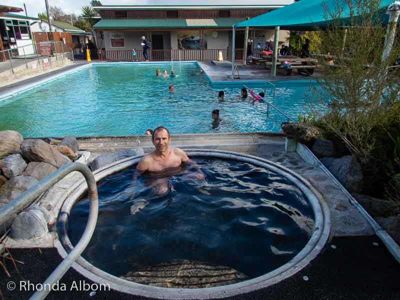 14 Best New Zealand Hot Springs - Relax, Soak, Unwind 5 man enjoying Waikite Thermal Pools in Rotorua, NZ