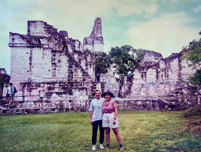 Visiting Tikal vs Chichen Itza: Marvels of Two Ancient Civilizations 2 Jeff and Rhonda Albom standing in front of ruins while visiting Tikal in Guatemala