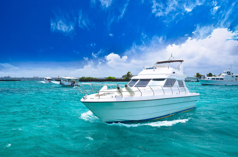 Large power boat near shore in crystal blue waters for an unforgettable boating experience.