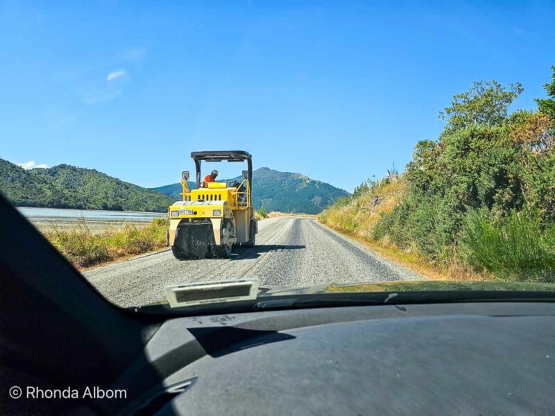 Fresh chipseal on a road between Nelson and Picton emphasises longer drive times, reminding visitors that one of the things not to do in New Zealand is to underestimate drive times