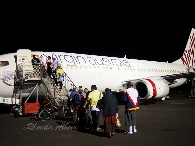 Virgin Australia at Faleolo Airport in Samoa with runway lights in the background