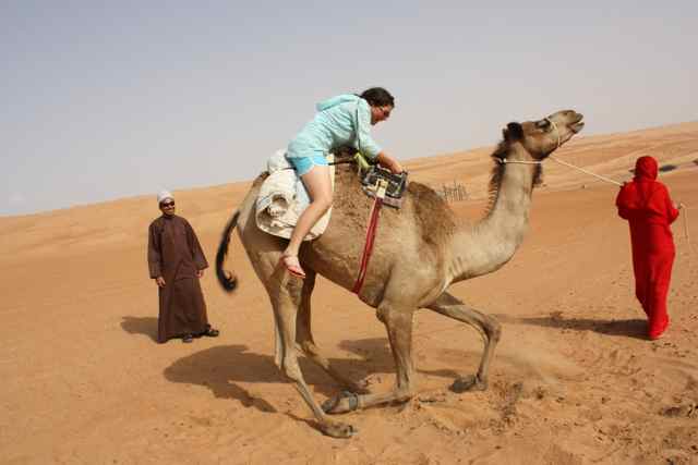 Melissa Albom getting up on a camel in a Bedouin Camp in the interior of Oman Melissa Albom getting up on a camel in a Bedouin Camp in the interior of Oman