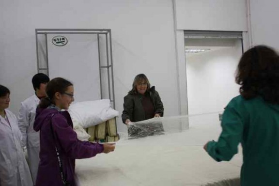 Stretching a layer of silk at the Silk factory in Suzhou China