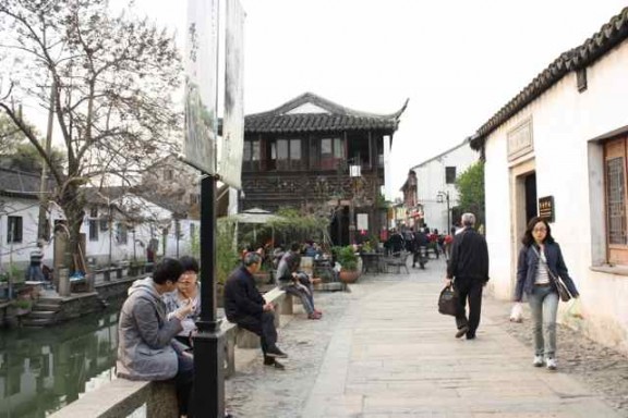 A couple eating chicken feet, and spitting the little bones onto the ground in Suzhou China